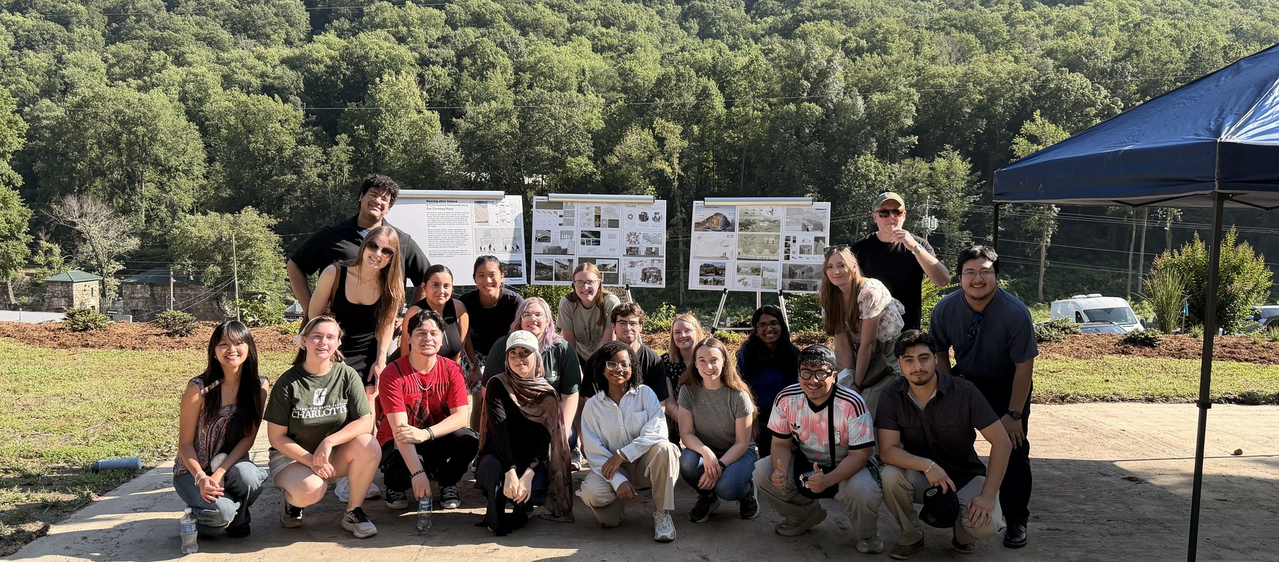 Architecture students lined up in front of displays at Chimney Rock picnic