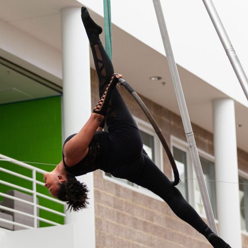 Girl hanging upside down on aerial hoop