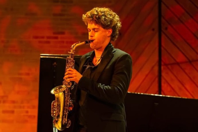 Elliott Stoffler playing a saxophone on stage