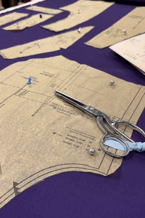 purple cloth and pattern on sewing table