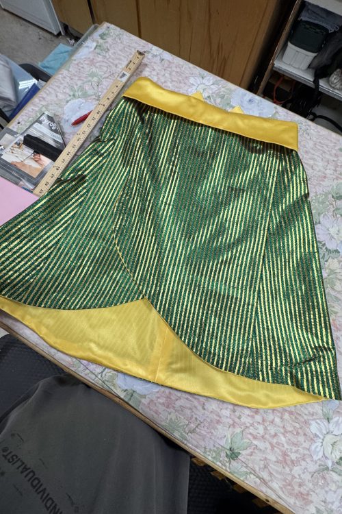 green costume skirt on sewing table