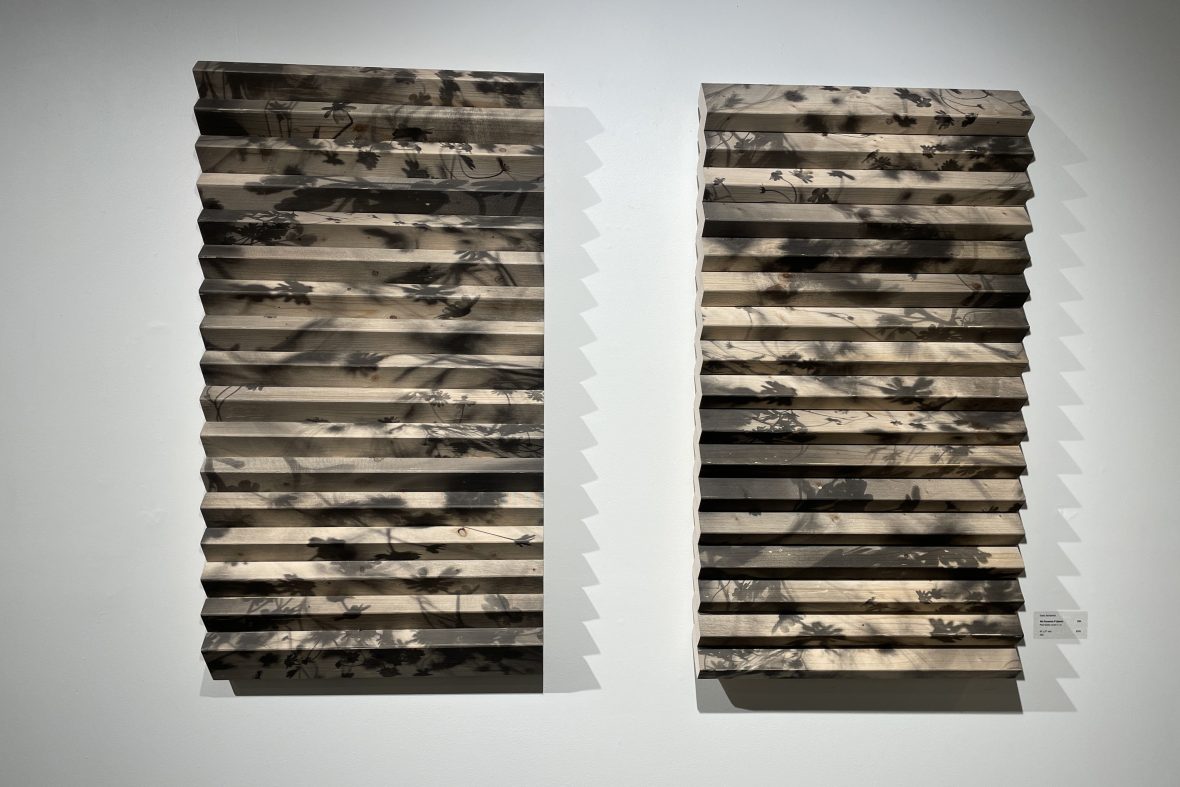 Two works by Susan Jedrzejewski hanging on gallery wall.