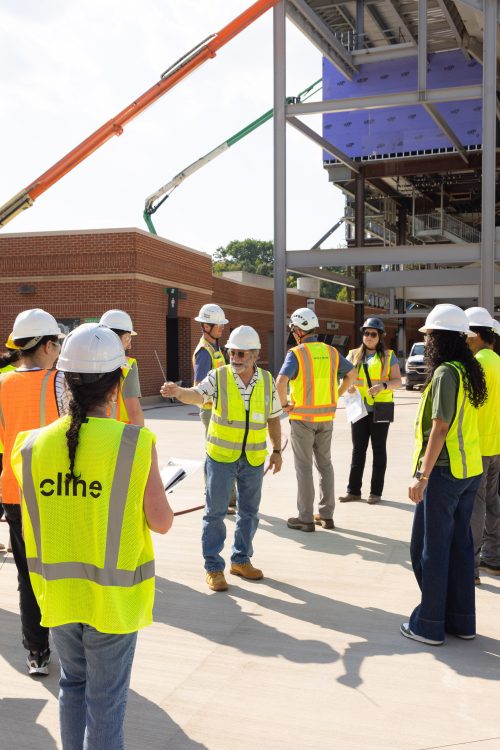 David Thaddeus and students in hard hats at a concrete company