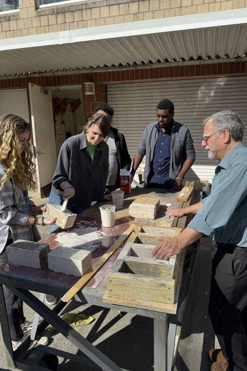 David Thaddeus with students behind the Storrs building, demonstrating brick molds