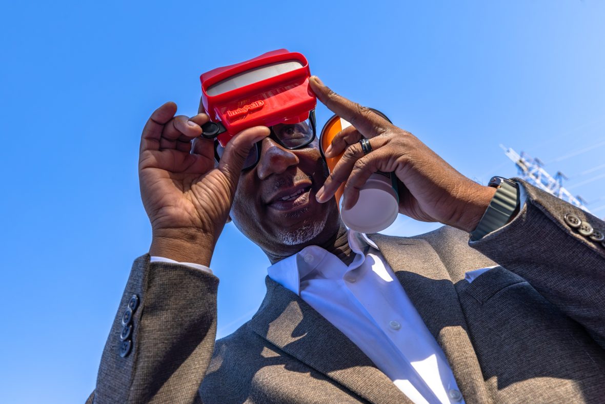 County Commissioner Mark Jerrell with a custom viewfinder of historic images at the L.C. Coleman Park event.