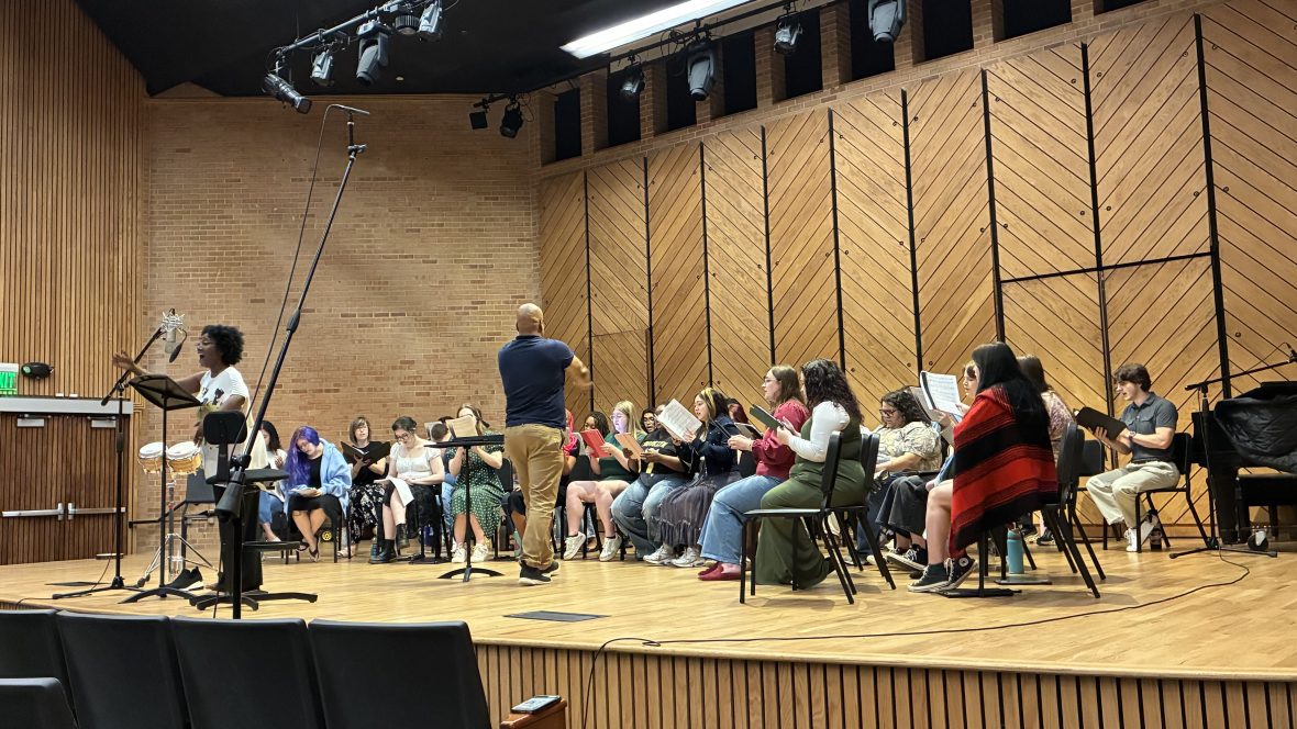 Sequina DuBose recording on the stage of Rowe Recital Hall with the University Chorale.