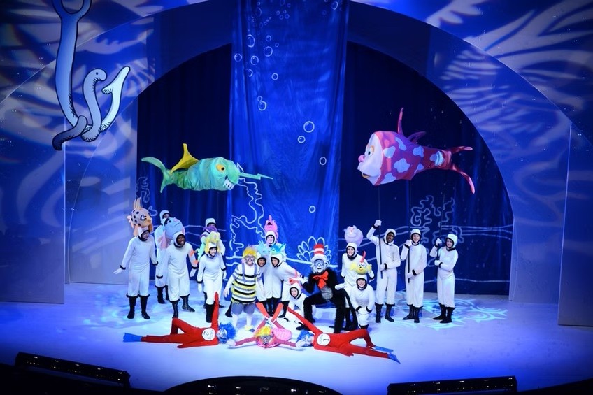 a group scene in the musical "Seussical" that shows an underwater scene with fish and blue lighting