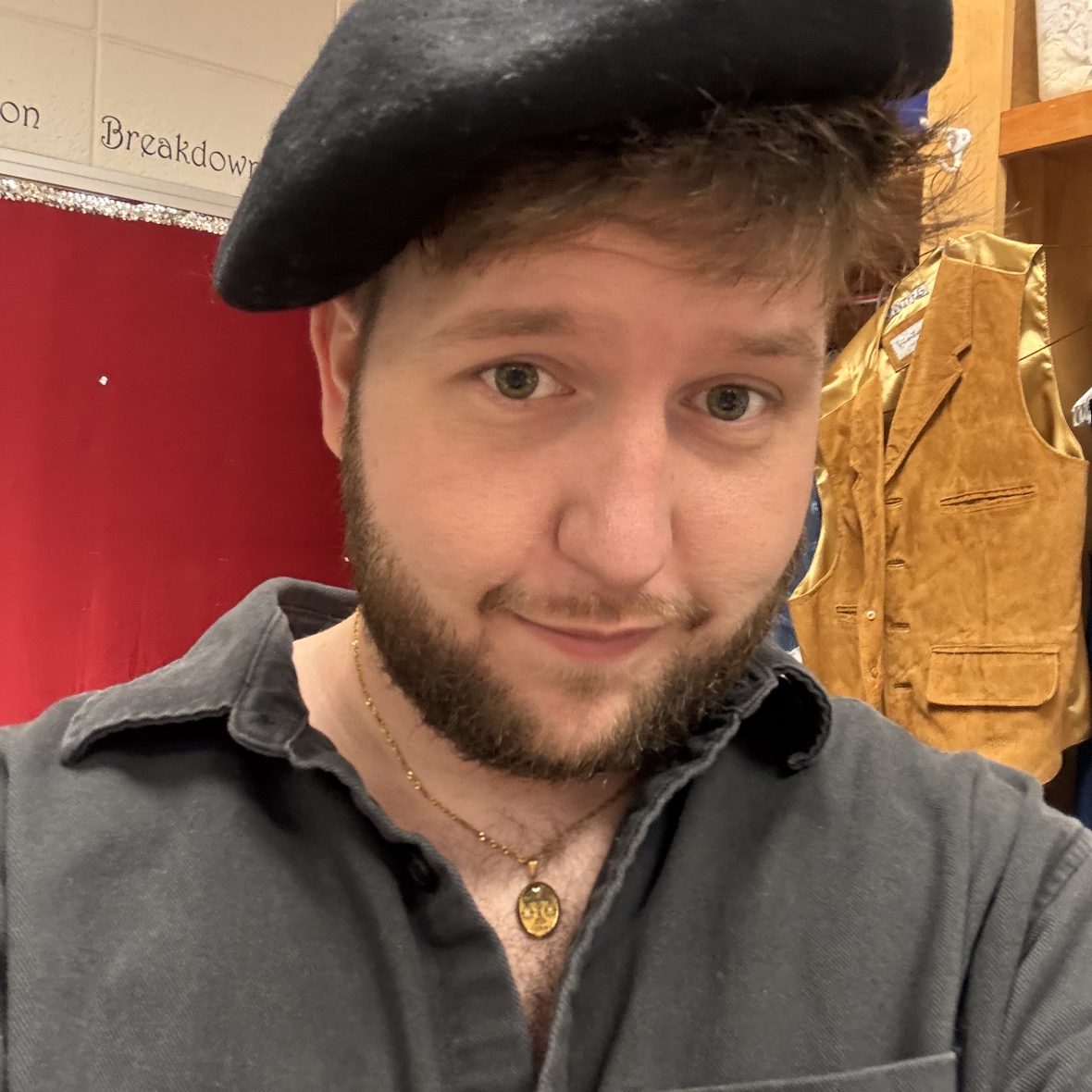 Headshot of Toby Lewis in a costume shop