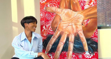 Artist Kalin Devone with her painting in the background