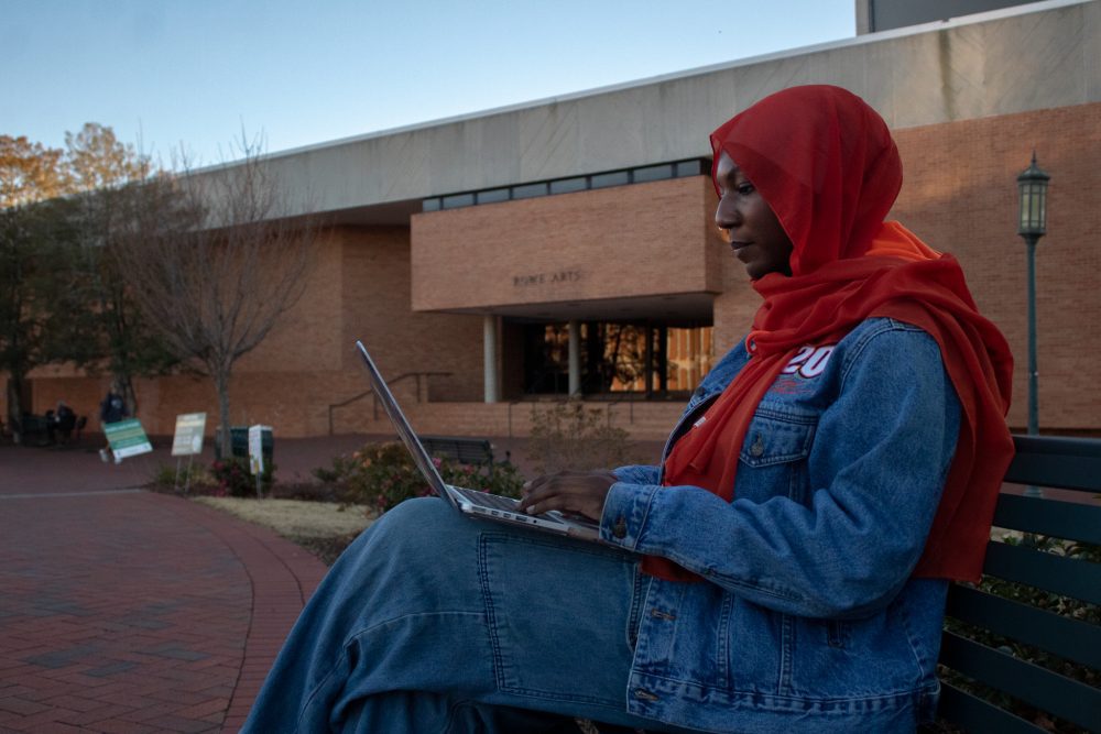 Student on her computer outside of Rowe