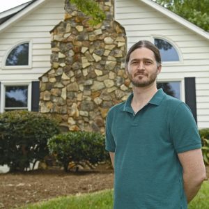 Clay Harper in front of the Sue Lemmond Helms Community Art House, where he is the inaugural artist-in-residence.