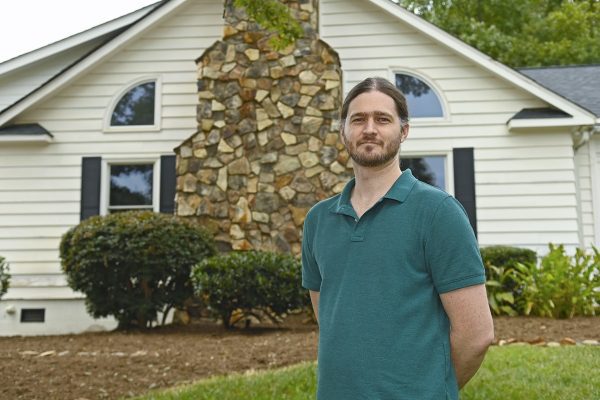 Clay Harper in front of Sue Lemmond Helms Community Art House