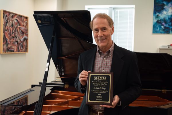 Dylan Savage shown in his studio with the award.