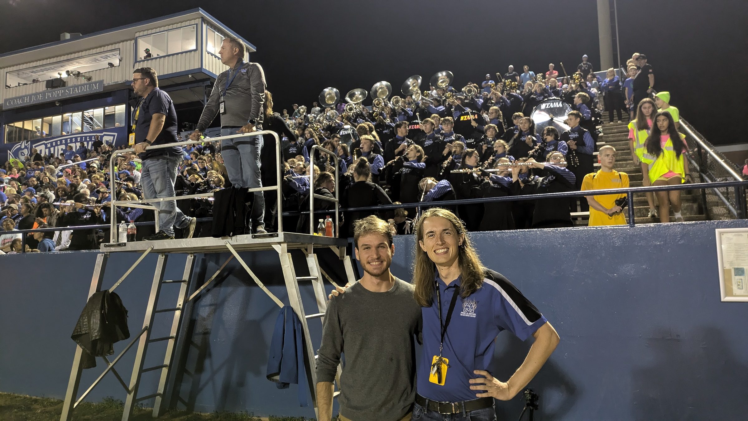 Adam Kallestad with a co-teacher at Mooresville High School football game.