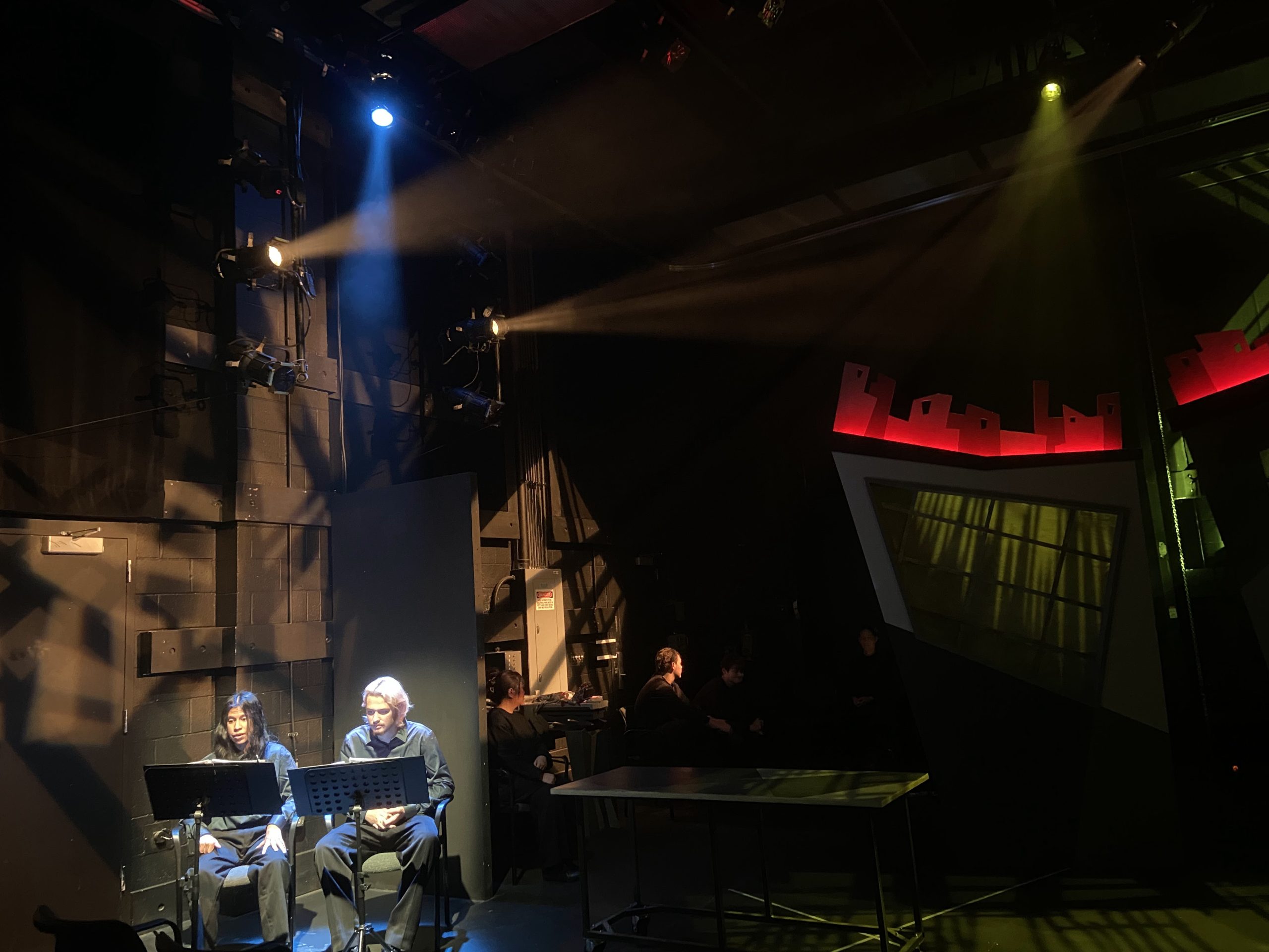 directing students on the side of the stage during a production