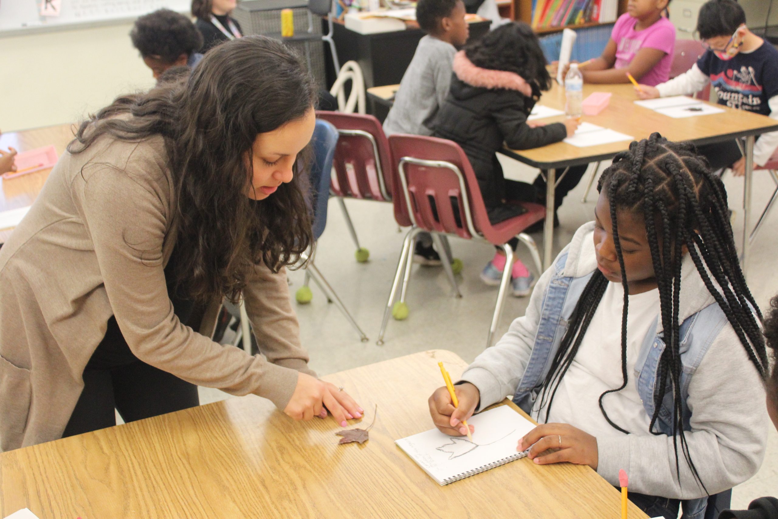 teacher teaching a student