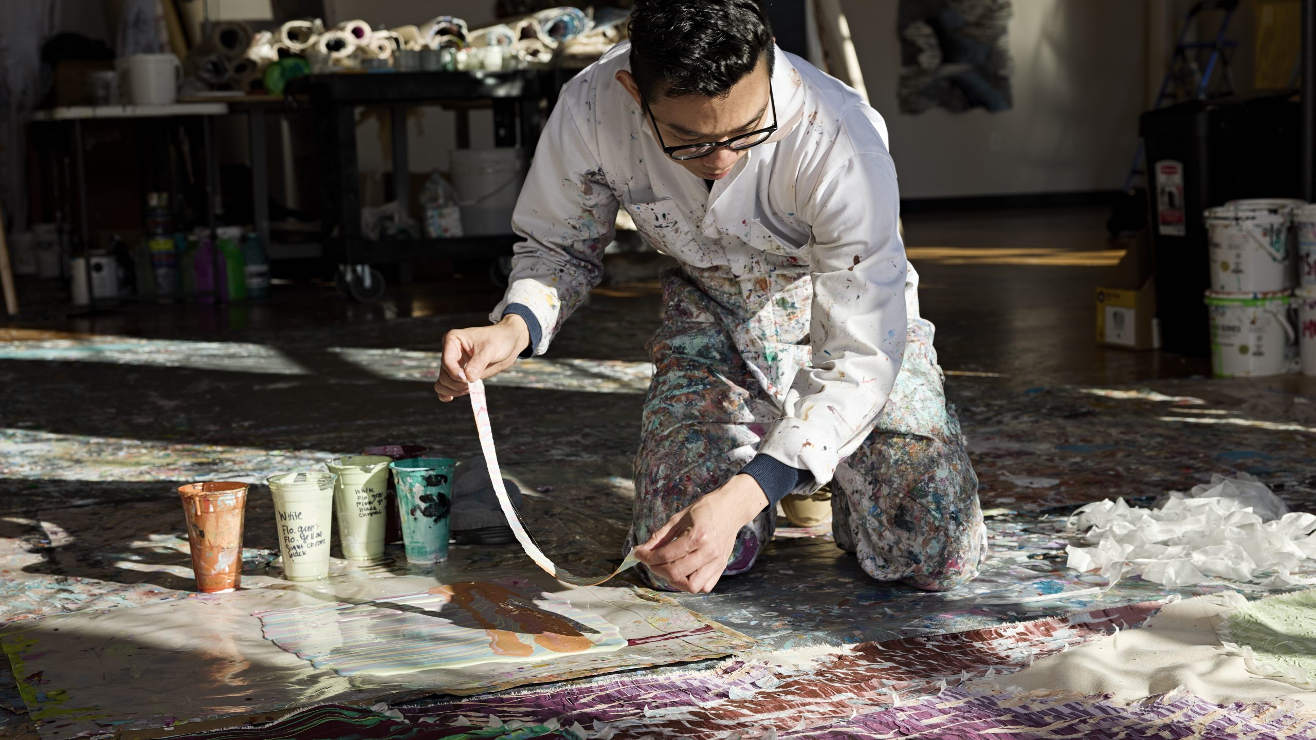 Kenny Nguyen painting in his studio