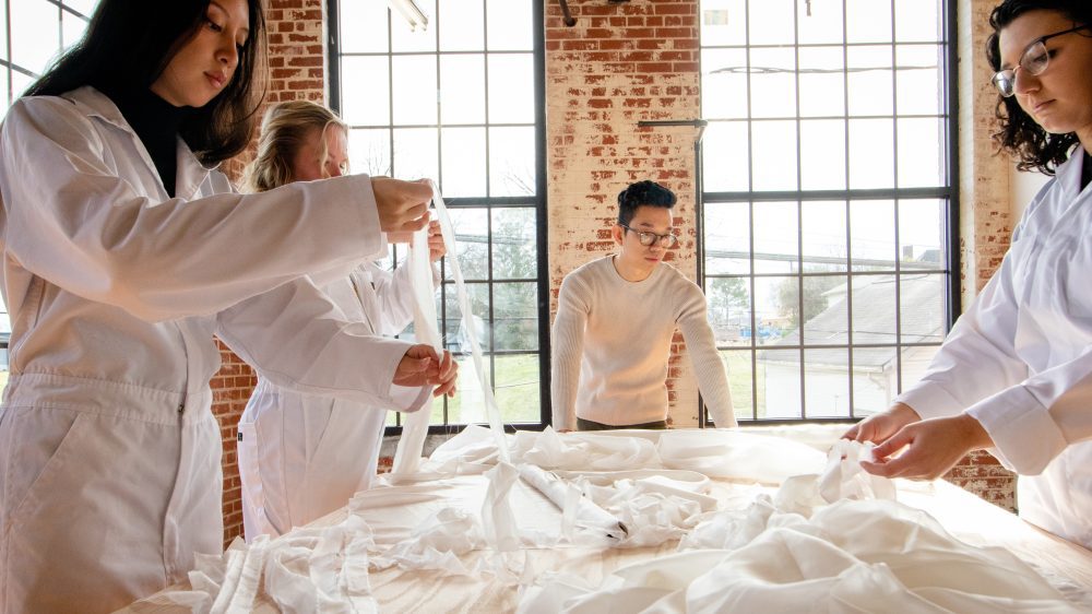 Kenny Nguyen with interns in his studio