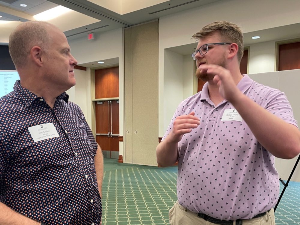 Music Department Chair Joe Skillen talks to student Will Wiand.