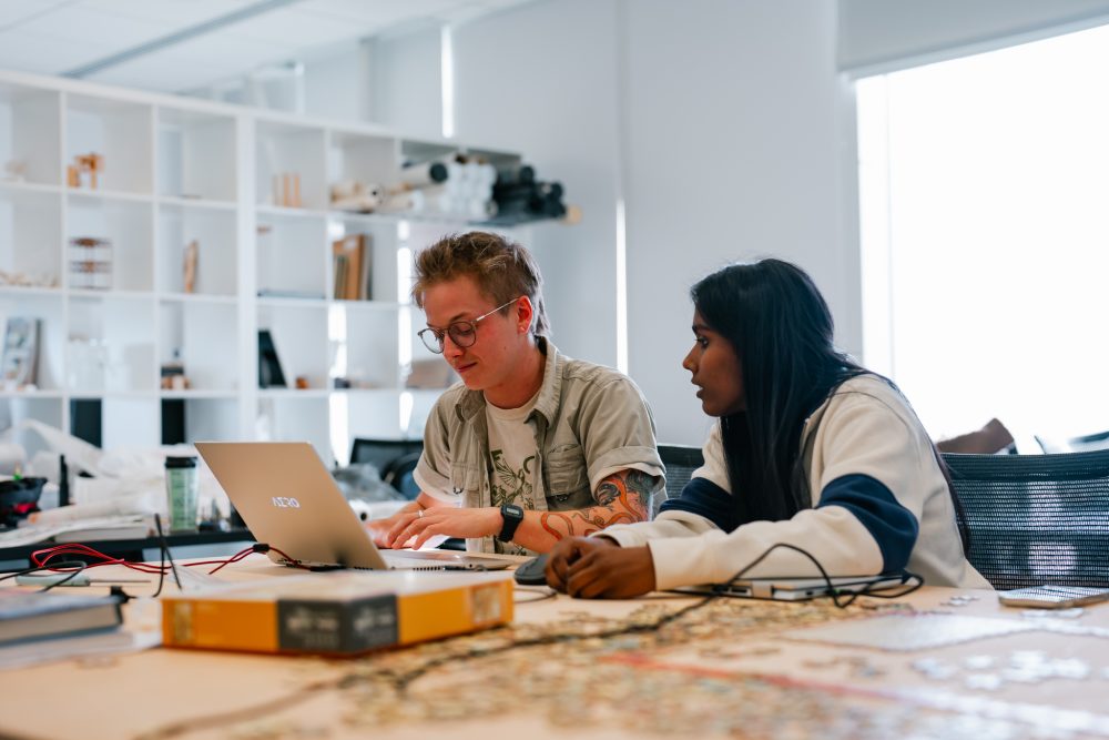 two architecture students working in a lab