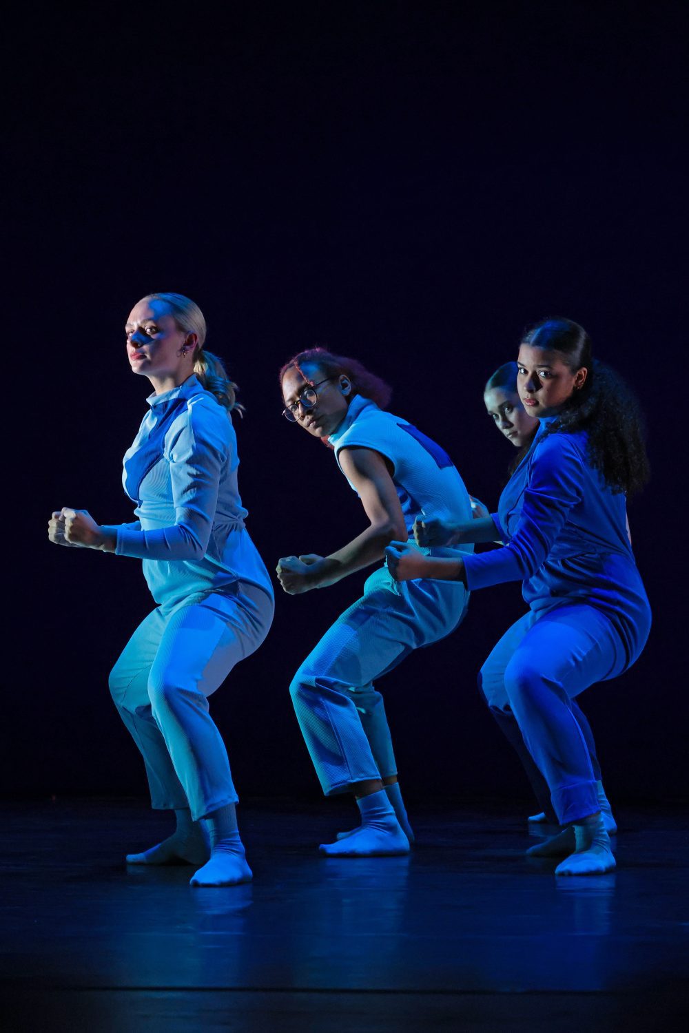 Four dancers performing a contemporary piece