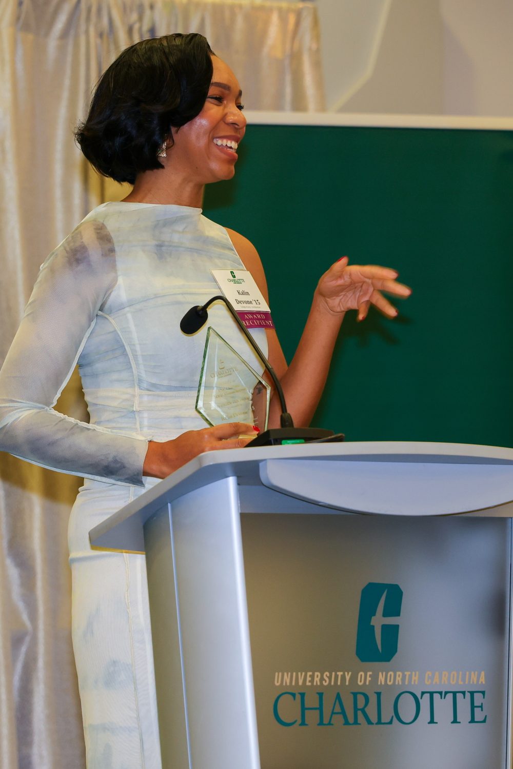 Kalin Devone speaking at award ceremony.