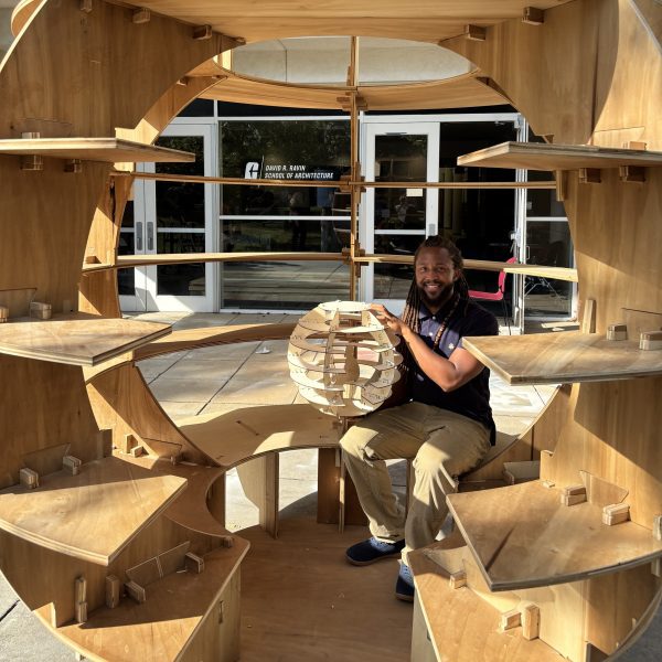 Kyle Spence sitting inside his EcoDome structure.